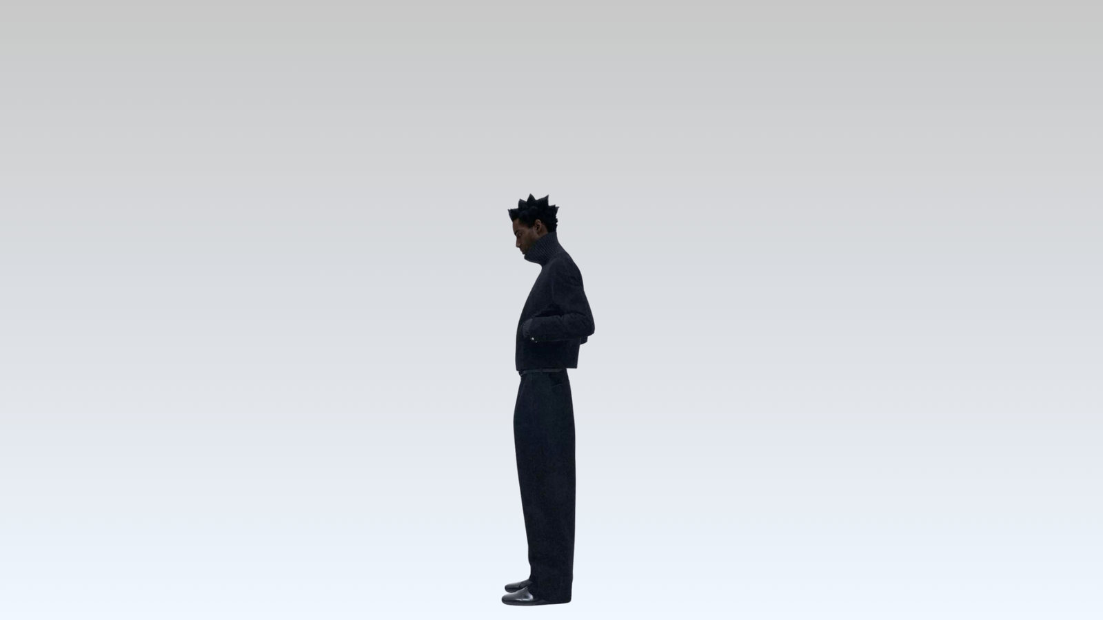 Person wearing a dark outfit with a cap on a white background